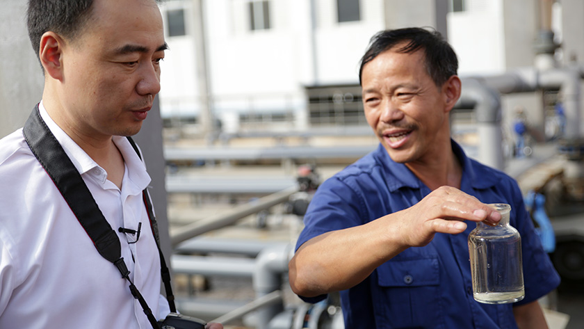 Ma Jun, IPE founder, inspecting water runoff from a factory in China.