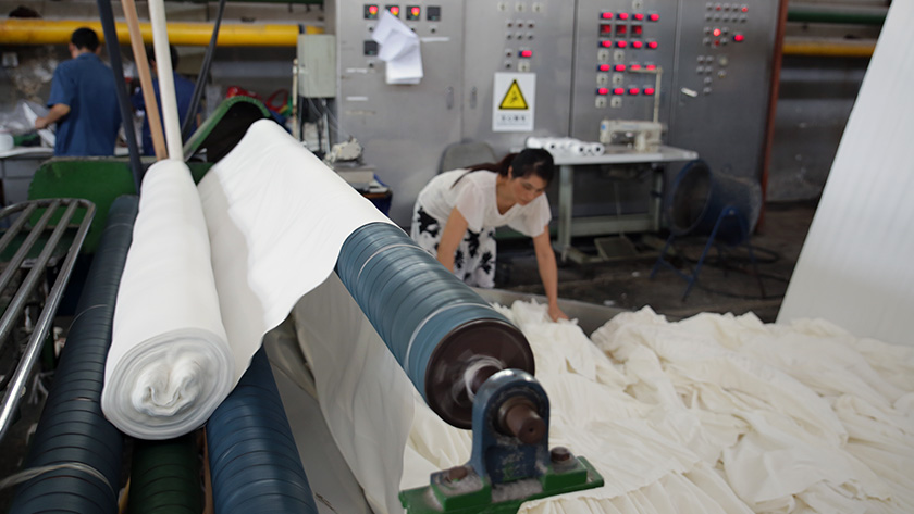 Textile worker laboring in a mill in China.