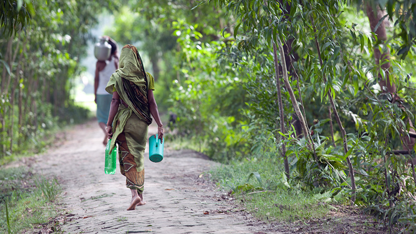 Women and girls often spend up to 6 hours each day collecting water: girl carrying water in rural India