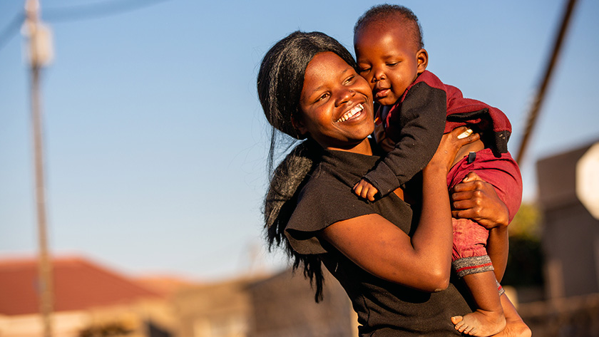 Dimakatso holding her smiling baby son, Goitsimang