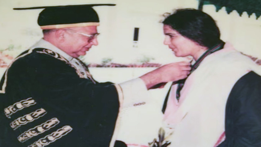 Governor of Karachi awarding Quratul a gold medal for first position in the Masters of Social Work program at Karachi University.