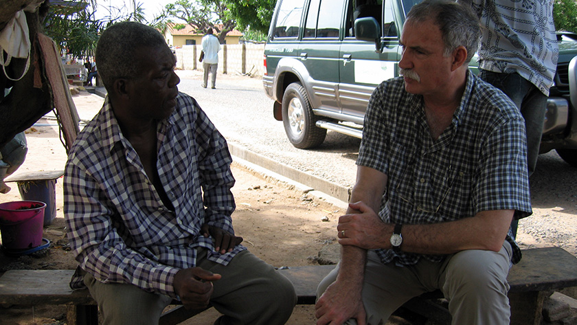 The author visiting a small roadside workshop with a BasicNeeds participant in Ghana.