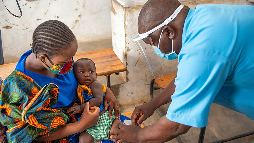 Raphael Salanga, HSA in Nkhotakota District, administers a routine vaccination to an infant in his community. Photo Credit: Homeline Media