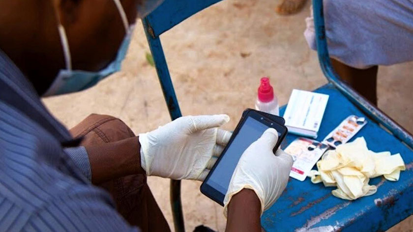 A Muso Community Health Worker in Mali checks the status of a patient with the Universal Health Coverage Mode app